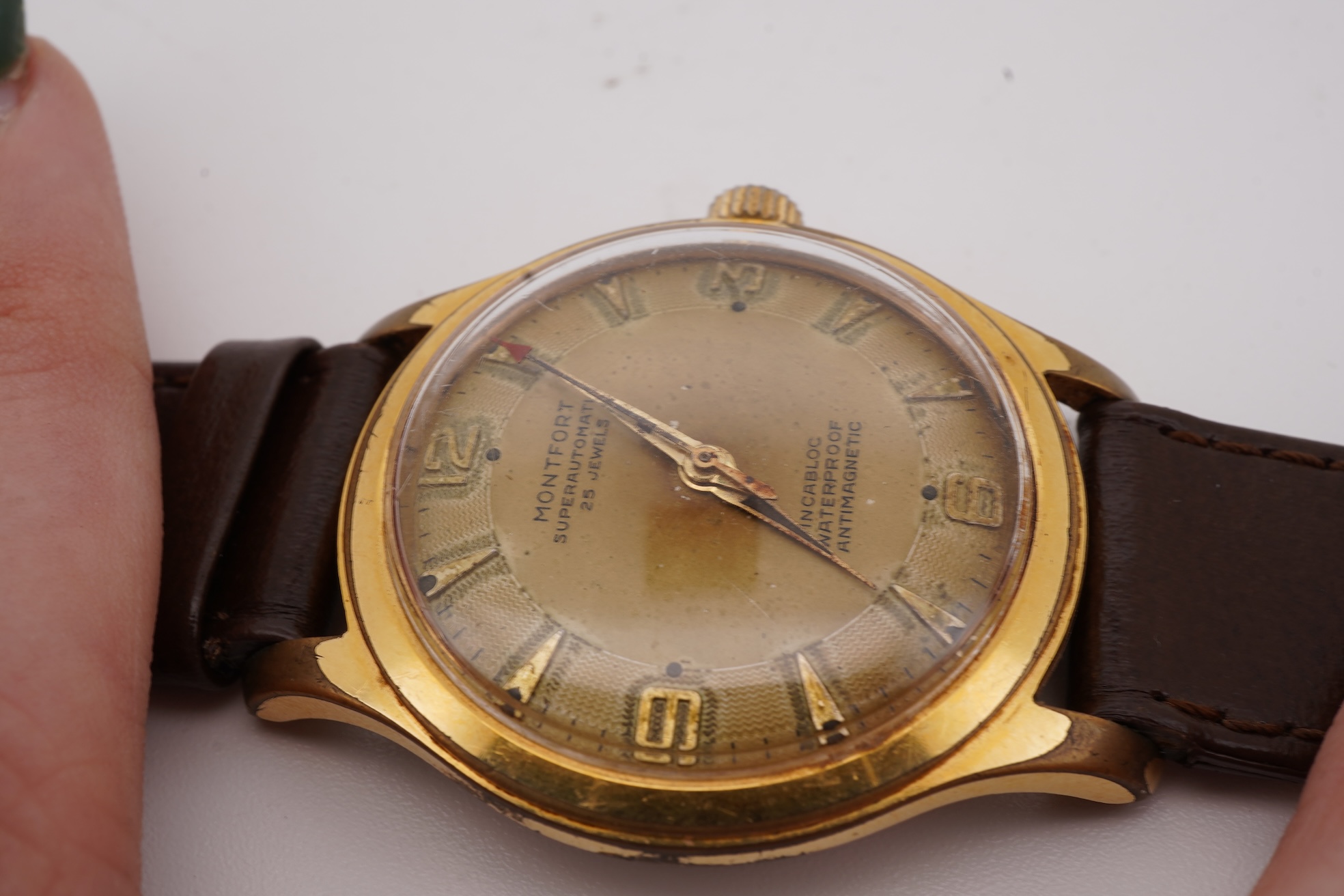 A gentleman's steel and gold plated Montfort Superautomatic wrist watch, with Roman and quarterly Arabic numerals, case diameter 34mm, on a later associated leather strap.